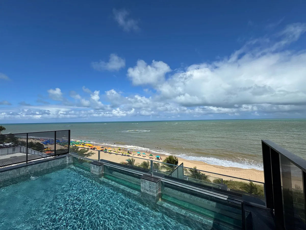 Foto de Flat beira-mar pé na areia com varanda AH 409